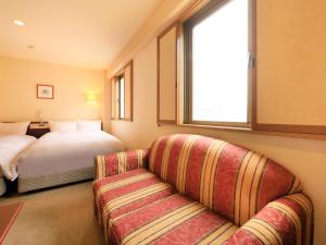 Letto o letti in una camera di Centurion Hotel Hamamatsu