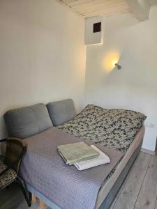 a bed in a small room with towels on it at AGRO-Jabłońscy in Miałkówek