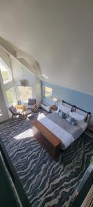 a bedroom with a large bed and a large rug at The Seaside Oceanfront Inn in Seaside