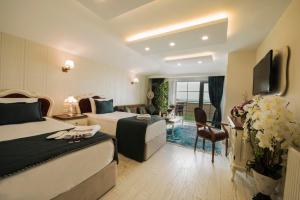 a hotel room with two beds and a television at Anatolia Hotel Airport in Trabzon