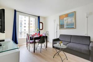 a living room with a couch and a table at Cosy Appartement Paris Porte de Versailles in Paris