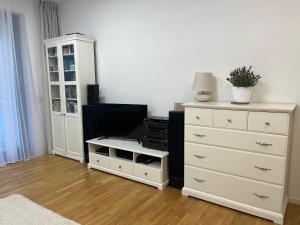 a living room with a dresser and a dresser at New and modern flat between Potsdamer Platz and Tiergarten in Berlin