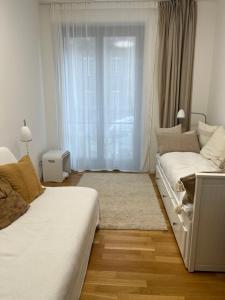 a bedroom with a bed and a couch and a window at New and modern flat between Potsdamer Platz and Tiergarten in Berlin