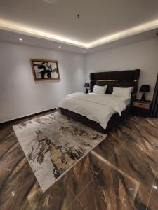 ein Schlafzimmer mit einem großen Bett und einem Teppich in der Unterkunft Gold Crest Apartments - DHA P4 in Lahore