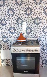 a stove with a pot on top of it in a kitchen at Rachid villa in Essaouira