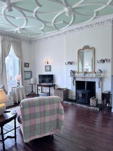 a living room with a couch and a fireplace at Unique apartment in stunning Manor house in Potterne