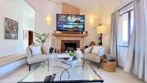 a living room with a fireplace and a tv at San Angel Villas in San Antonio