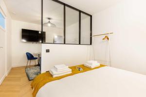 ein Schlafzimmer mit einem Bett mit Handtüchern darauf in der Unterkunft Chic Apartment in the Prestigious Saint Honoré in Paris