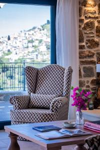 a living room with a couch and a coffee table at RODON Luxury Villas in Skopelos Town