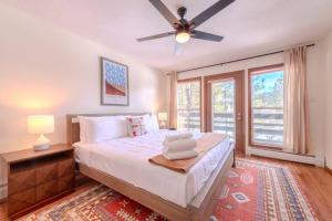 a bedroom with a bed and a ceiling fan at Grand Angel Fire mountain luxury ski chalet in Angel Fire