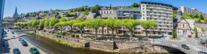 a city with a river and a bridge and buildings at La Villa Lumière - 3 chambres in Tulle