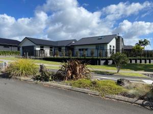 a house on the side of a road at Relax on Roseberry - Whitianga Holiday Home in Whitianga