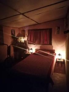 a bedroom with two beds and a red curtain at The Jungle Life Homestay Thangamalay Sanctuary Haputale by Gisela Sivam in Haputale