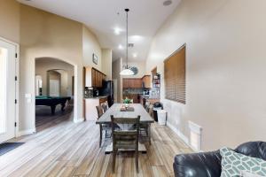 a dining room and living room with a table and chairs at The Beach House in Surprise