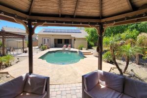 a patio with two chairs and a swimming pool at The Beach House in Surprise