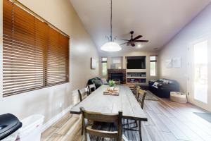 a dining room and living room with a table and chairs at The Beach House in Surprise