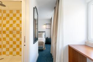a room with a bedroom with a bed and a mirror at Westlight Lisboa Madalena in Lisbon +41 photos