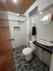 a bathroom with a toilet and a sink at Ruta Jardín in Jardin