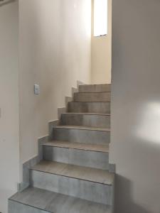 a staircase in a white building with a window at Casa em Jauá in Camaçari