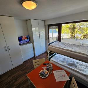 a room with a bed and a table and a tv at Hotel Ditzingen in Ditzingen