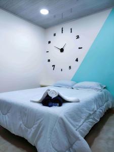 a bedroom with a large clock on the wall at Hostal Carvajal in Bogotá