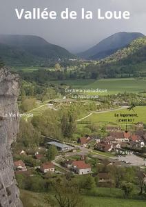 a view of a village in the mountains at Maison de Vacances - vue panoramique rivière in Ornans