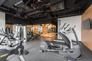 a gym with several cardio machines in a room at Central Apartments Katowice - City Center - Luxury Studio - S74 in Katowice