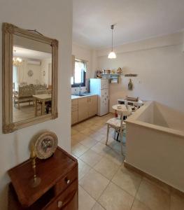 a kitchen and living room with a mirror and a tub at Antique Apartment in Afitos