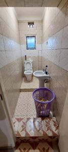 a small bathroom with a toilet and a sink at Home sweet home in Kigali