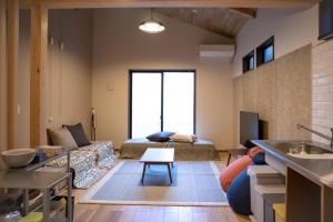 a living room with a couch and a table at Tomoeyado - Vacation STAY 05898v in Shimada