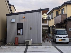 a white truck parked in front of a building at Tomoeyado - Vacation STAY 05898v in Shimada