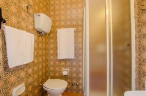 a bathroom with a toilet and a shower with towels at Hotel Del Buono Wellness & Medical Spa in Chianciano Terme