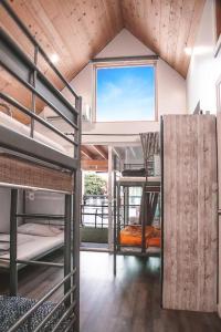 a room with bunk beds and a window at Roomi in Los Angeles