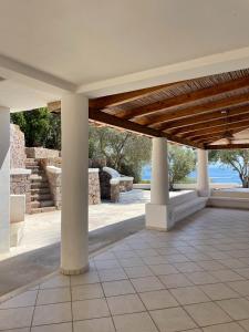 a pavilion with columns and a stone wall at Villa Katy in Panarea +8 photos