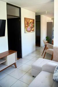 a living room with a painting of fruits on the wall at Apartamento entero 2 cuartos 2 baños in Piura