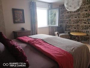 a bedroom with a bed and a brick wall at Holiday home Danube Valley 