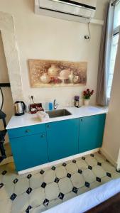 a kitchen with a sink and a counter top at מלון בירת החומות• The Walled Capital Hotel in Jerusalem