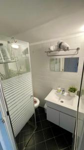 a white bathroom with a sink and a toilet at מלון בירת החומות• The Walled Capital Hotel in Jerusalem