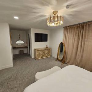 a bedroom with a bed and a mirror and a chandelier at Refreshing POOL Old Town Scottsdale 4 Bdr 3 FULL Baths in Scottsdale