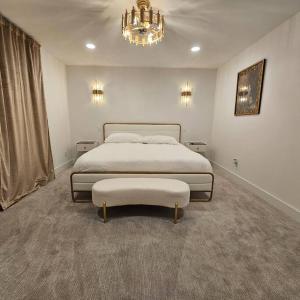 a bedroom with a large bed and a chandelier at Refreshing POOL Old Town Scottsdale 4 Bdr 3 FULL Baths in Scottsdale +64 photos
