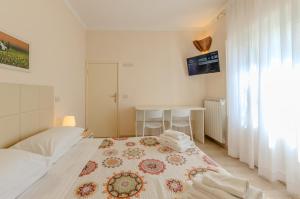a bedroom with a bed with a rug on it at Hotel Del Buono Wellness & Medical Spa in Chianciano Terme +84 photos