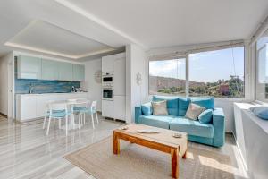 a living room with a blue couch and a table at Ocean View Apartment Montesol I in Adeje
