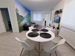 a living room with a white table and chairs at Blue apartaments in Cluj-Napoca
