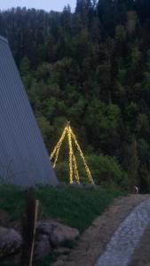 a lit up arch in the middle of a field at Landhaus Borjomi in Borjomi