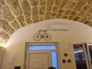 a bike on the wall above a door at Azzurra Home in Terrasini