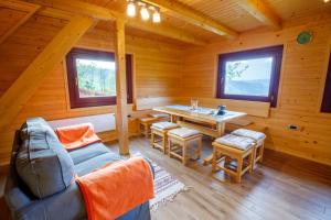 a log cabin with a dining room and a table at Bomas house in Cerkno