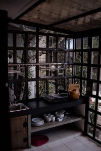 a kitchen with a counter with a sink and a window at Hotel Rocaval San Cristóbal de las Casas in San Cristóbal de Las Casas