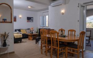 a dining room and living room with a table and chairs at Dubrovnik Airport Apartment Tea in Durovići