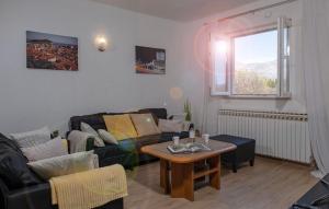 a living room with a couch and a table at Dubrovnik Airport Apartment Tea in Durovići