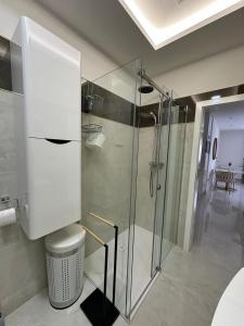a bathroom with a glass shower and a toilet at Apartman AM in Posušje